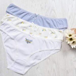 Three sets of elegant women's cotton panties displayed with floral decorations.